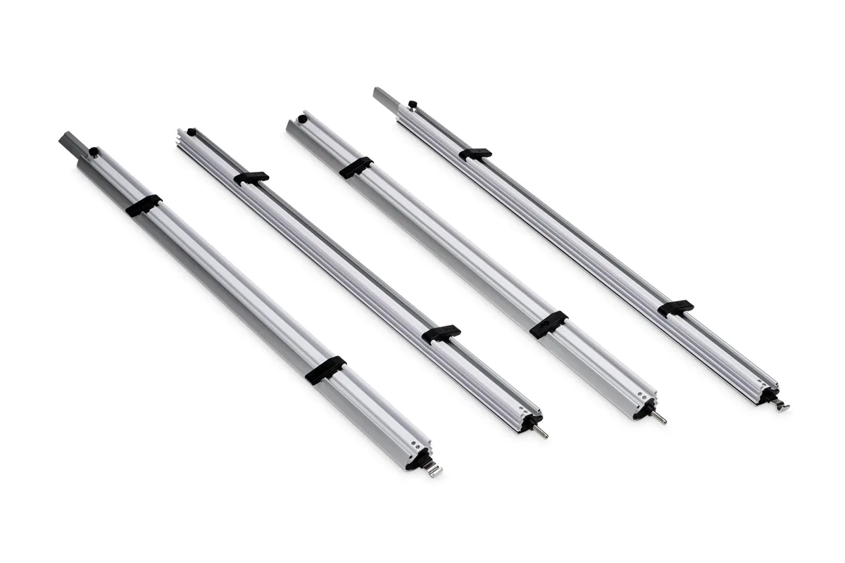 Four Dometic anti-flap kit rafter arms laid out flat, showing the telescopic aluminium tubing and end fittings included in the kit