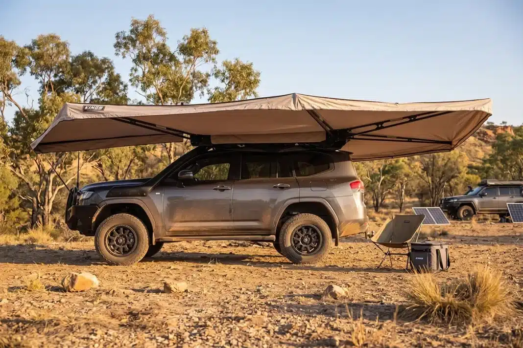 Adventure Kings 270 awning deployed over a Toyota LandCruiser at an outback campsite during golden hour