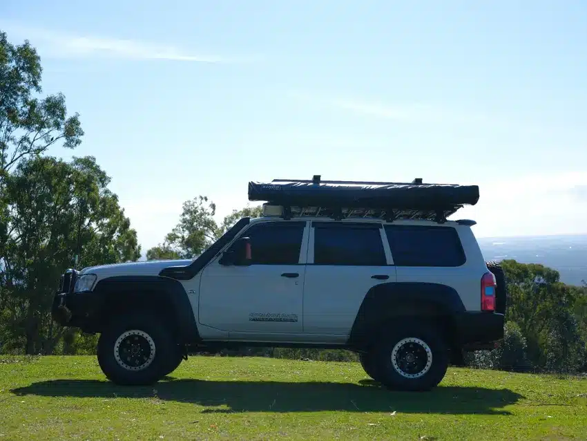 Adventure Kings 270 awning packed and stowed on the roof rack of a Nissan Patrol