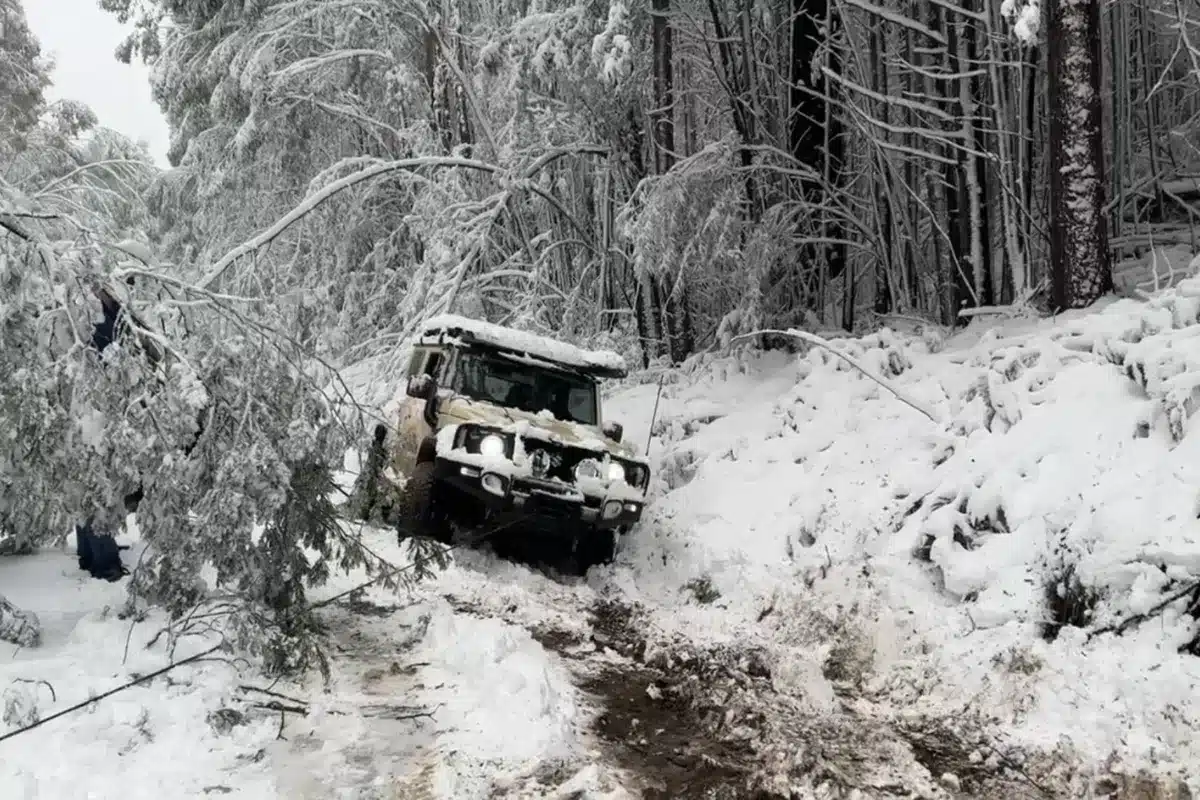 jimny winching in snow off side of the mountain