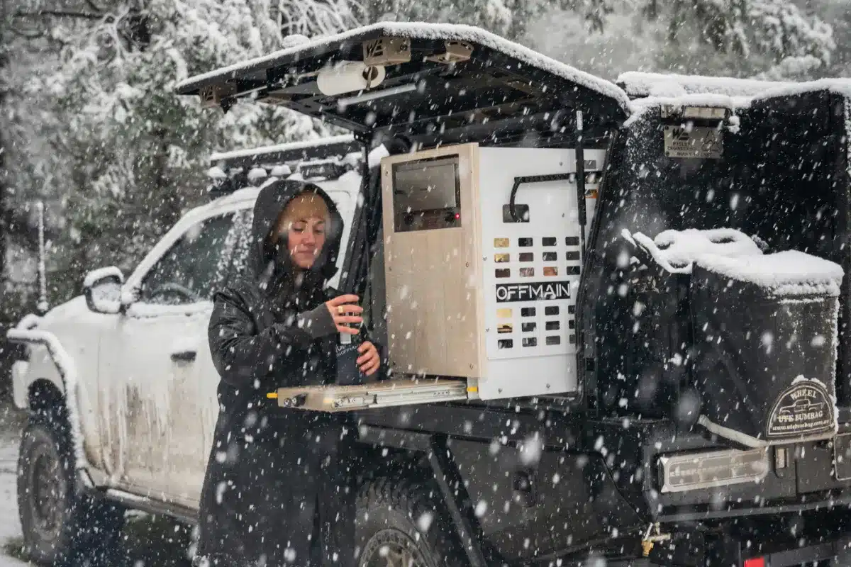 cooking in snow at back of canopy in, snow falling heavily