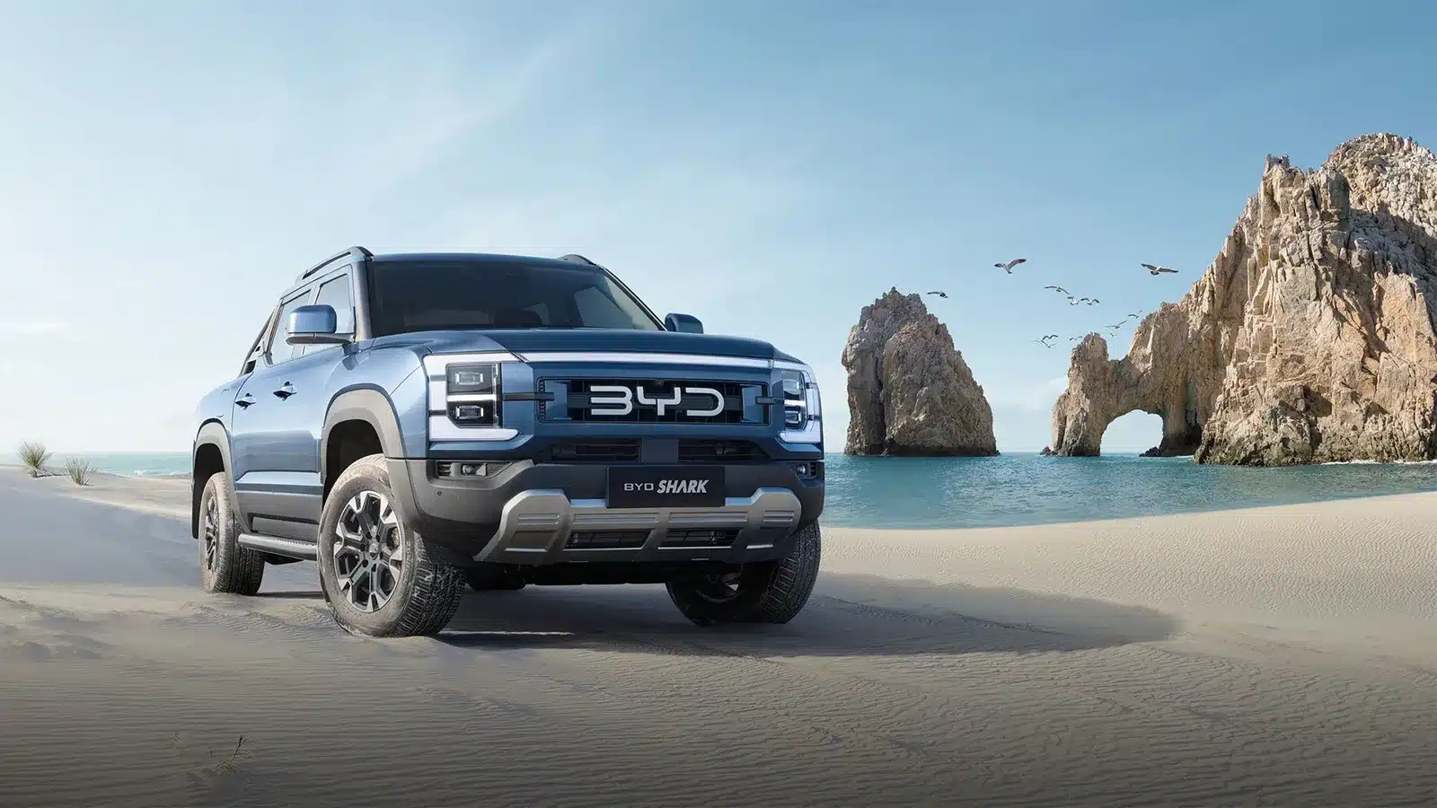 BYD Shark 6 PHEV ute on a sandy beach — a new electric tow vehicle option for Australian caravanners