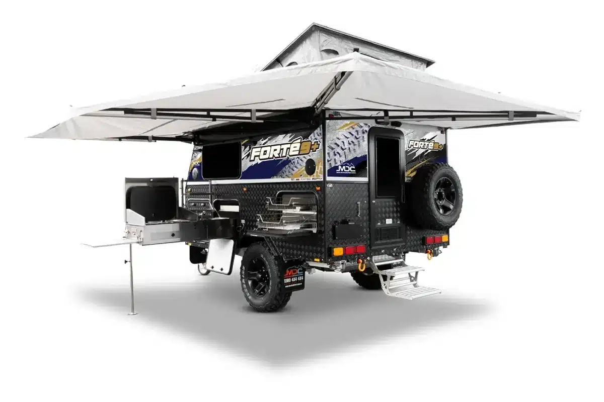 MDC Forte 9 Plus hybrid camper with 270-degree awning deployed and external slide-out kitchen extended, showing off-road build and chequerplate construction