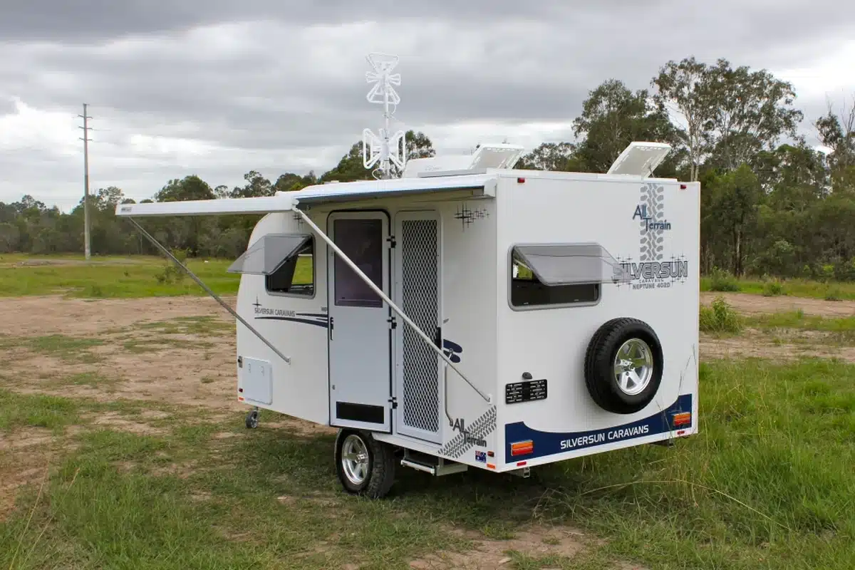 Silversun Neptune 402 All Terrain caravan exterior with awning deployed, showing compact single-axle Queensland-built construction and spare wheel