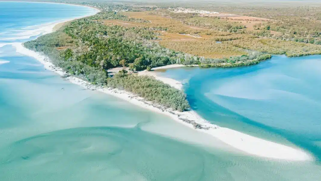 theodolite-creek-woodgate-aerial Aerial view of Theodolite Creek at Woodgate Beach showing white sandbars, shallow turquoise water, and surrounding coastal bushland