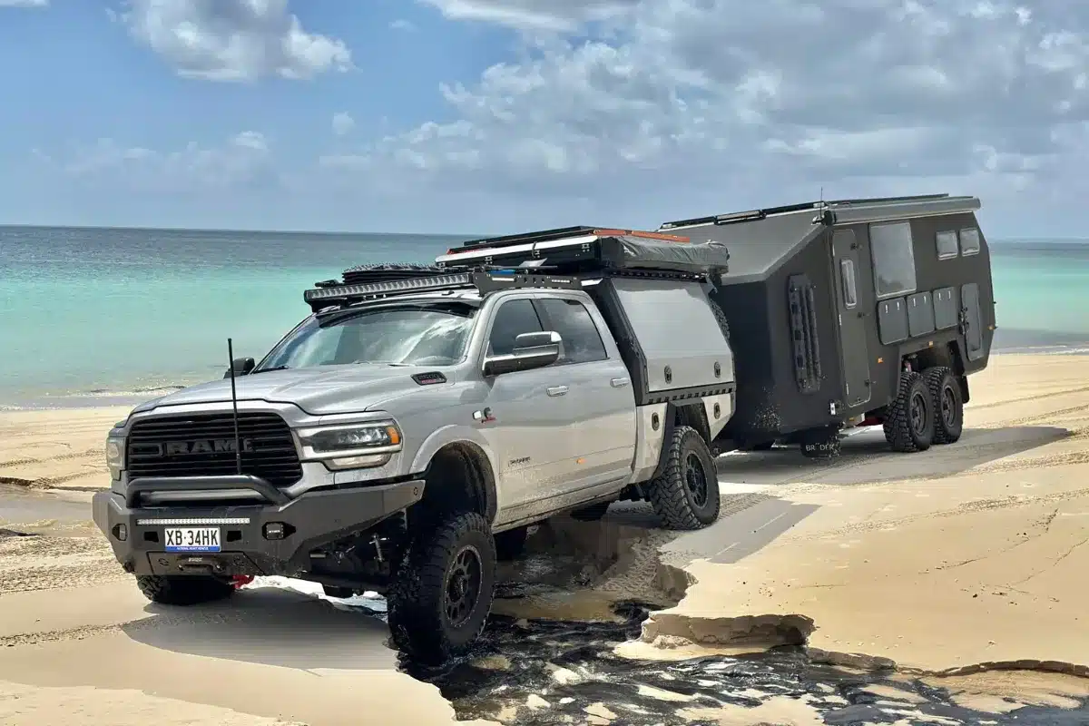 bruder caravan being towed on beach