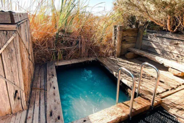 Wooden decked artesian spa pool at Coward Springs campground on the Oodnadatta Track