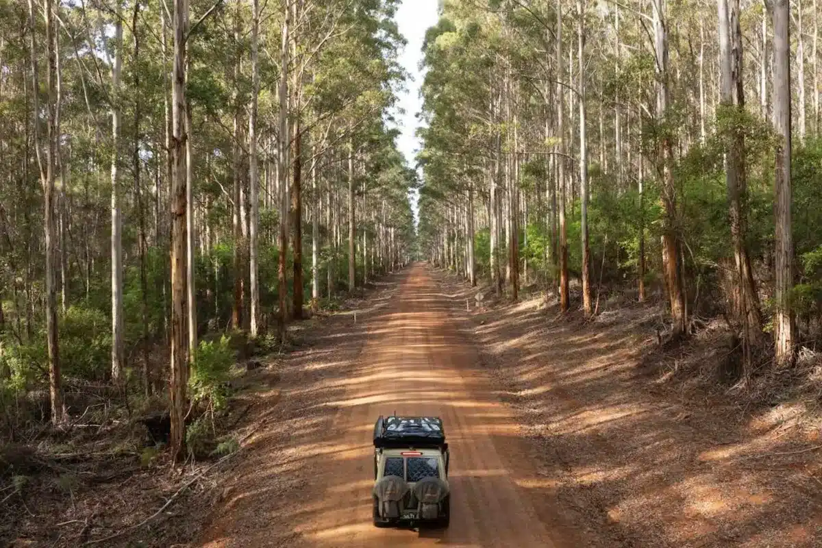 car travelling on dirt road with solar panels