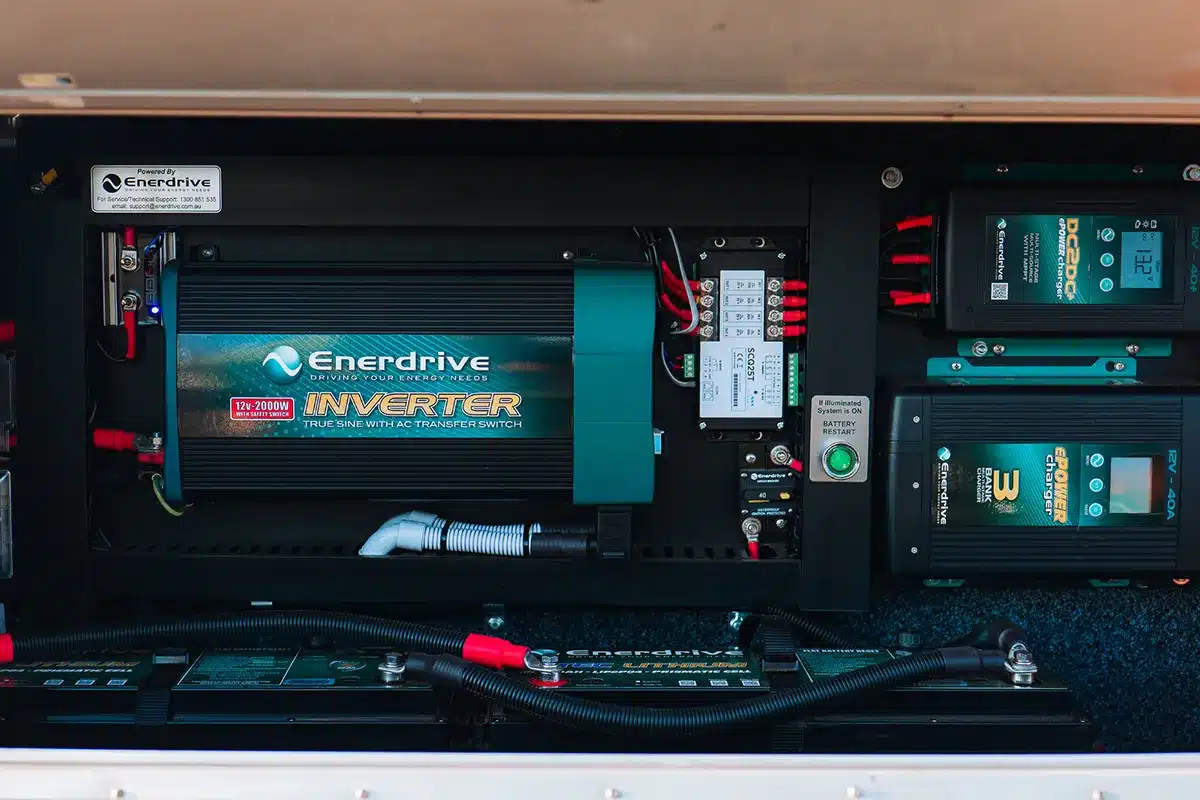 Enerdrive caravan power system installed in a storage bay showing 2000W inverter, DC-DC charger, 40A battery charger and LiFePO4 lithium batteries