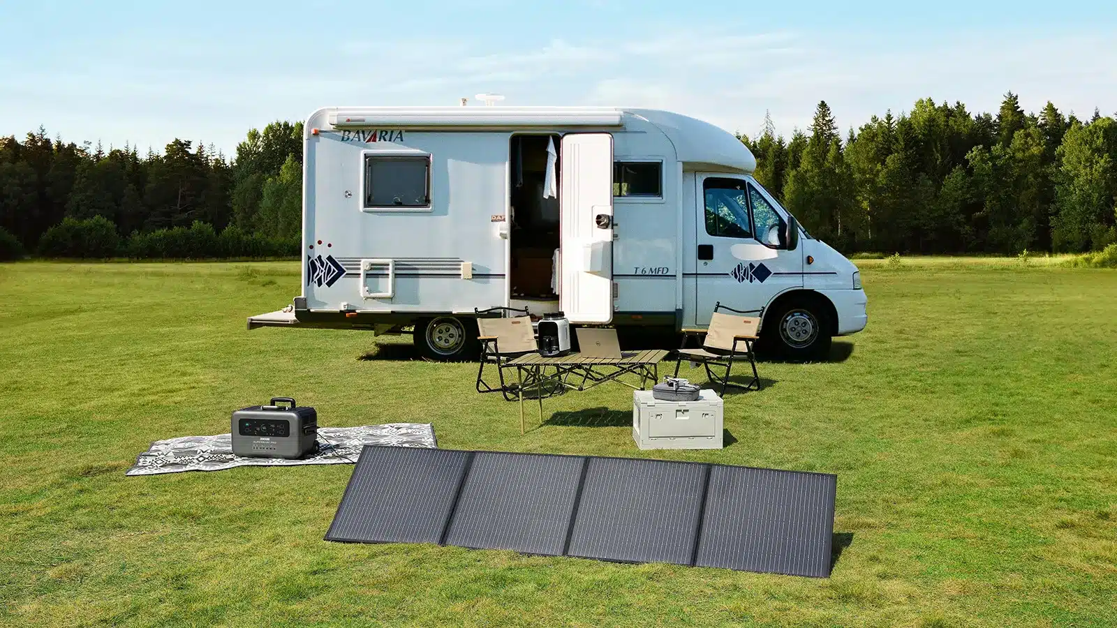 Portable folding solar panels laid out at a free campsite in front of a motorhome with a portable power station and camp chairs