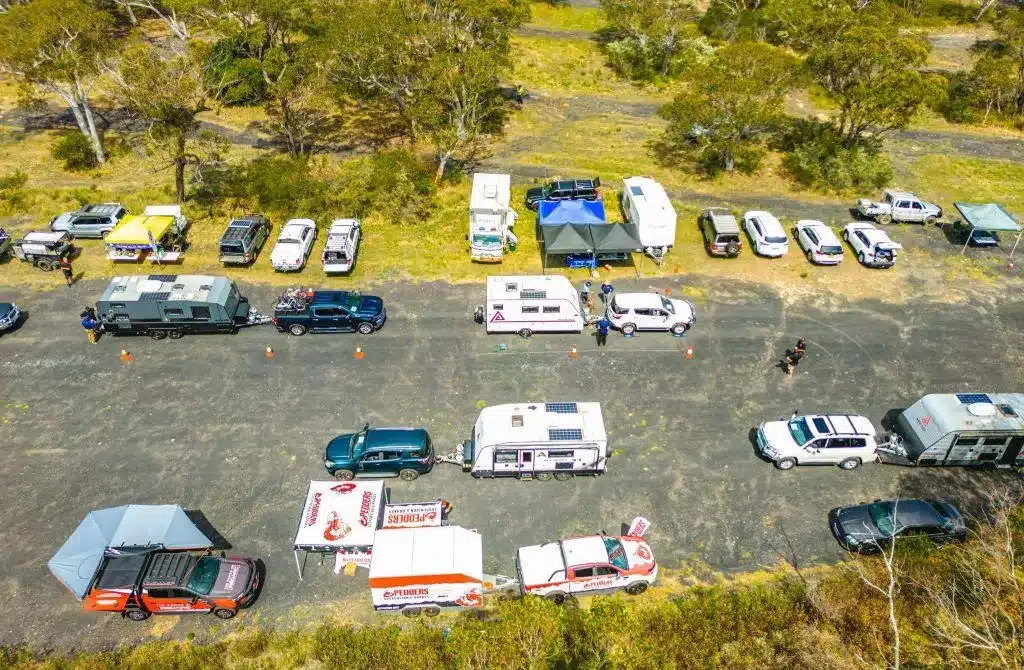 Aerial view of caravans and tow vehicles lined up at a roadside weight compliance event