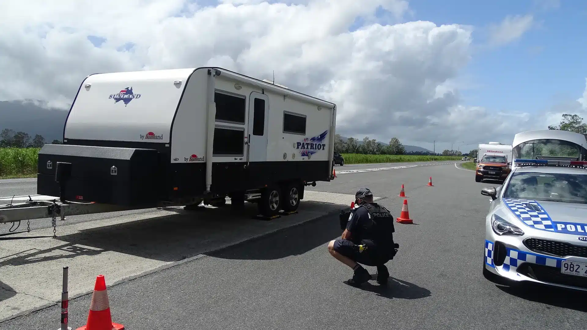 police-checking-caravan-weight Police officer inspecting a Sunland Patriot caravan's weight at a roadside checkpoint