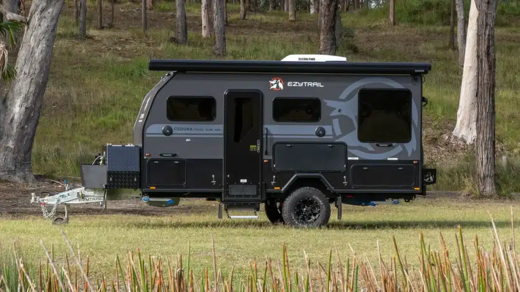 Ezytrail Ceduna 15FRS Club MK4 off-road camper set up in bushland with awning extended and roof-mounted air conditioner