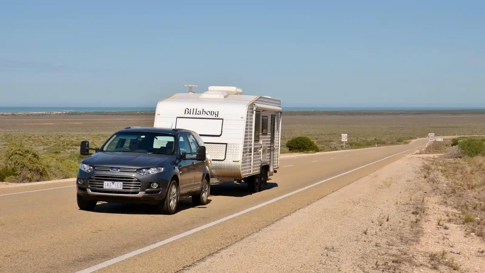 Ford Territory towing a Billabong caravan along the Eyre Highway near Eucla in Western Australia