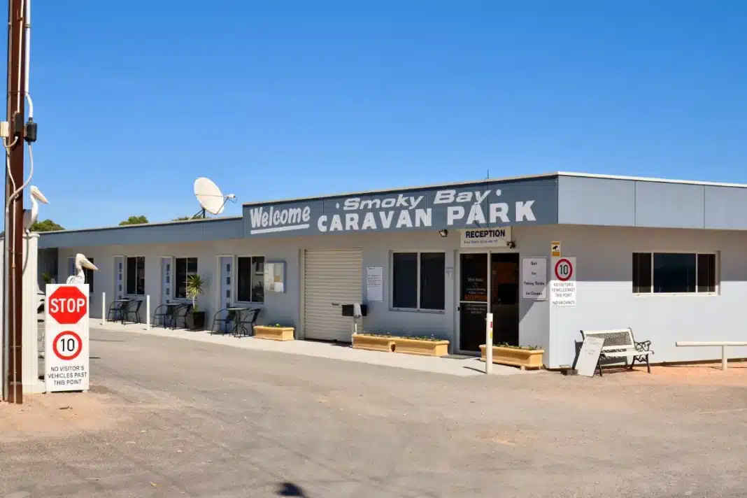 Reception building of the Smoky Bay Caravan Park in South Australia, with a stop sign at the entry